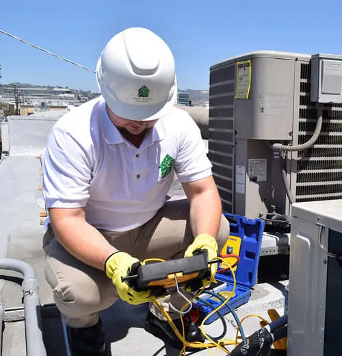 Image of a Home Upgrade Specialist employee optimizing an HVAC system for peak effectiveness.