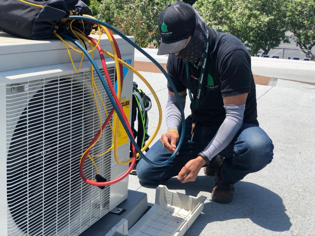 Dedication in action: Our skilled technician meticulously works on a client's HVAC unit, ensuring optimal performance and home comfort