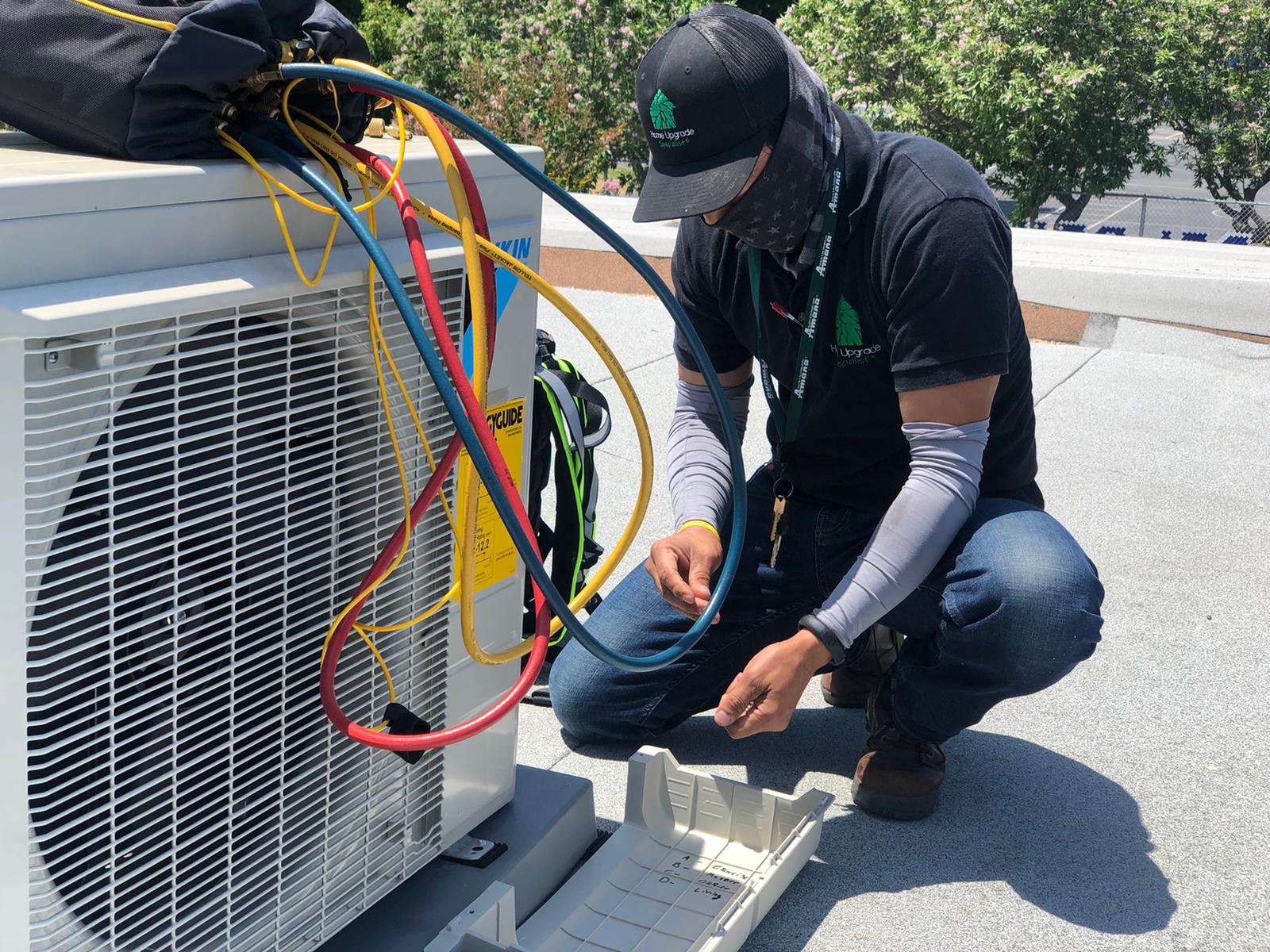 HVAC Tune-Up: Our skilled technician meticulously works on a client's HVAC unit, ensuring optimal performance and home comfort